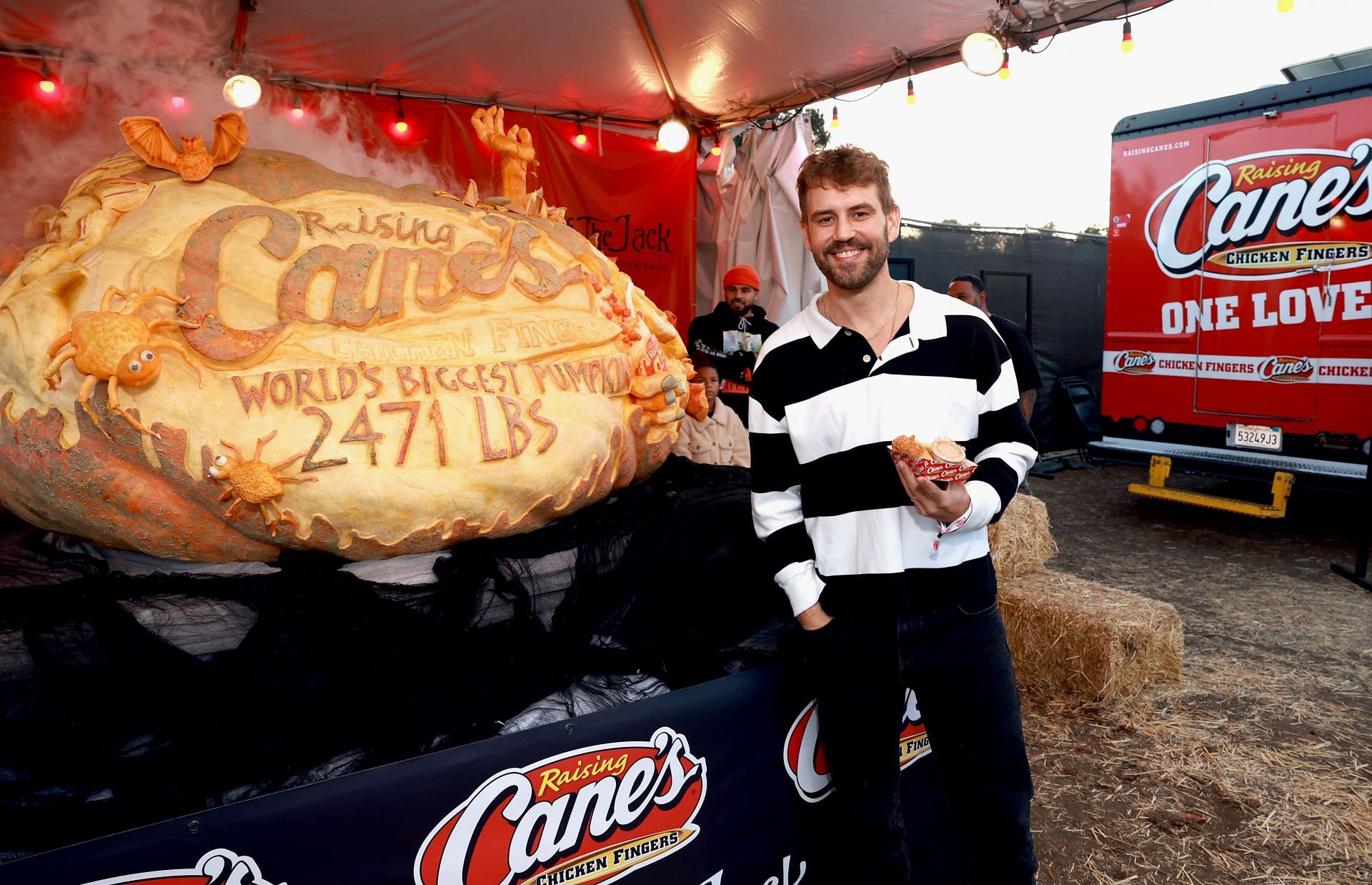 Nick Viall attends Raising Cane's unveiling of the world's biggest pumpkin with Todd Graves at Nights of Jack (Image via Getty)
